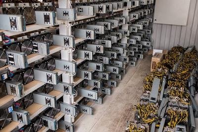 A vast expanse of mining rigs humming with activity inside a mining farm